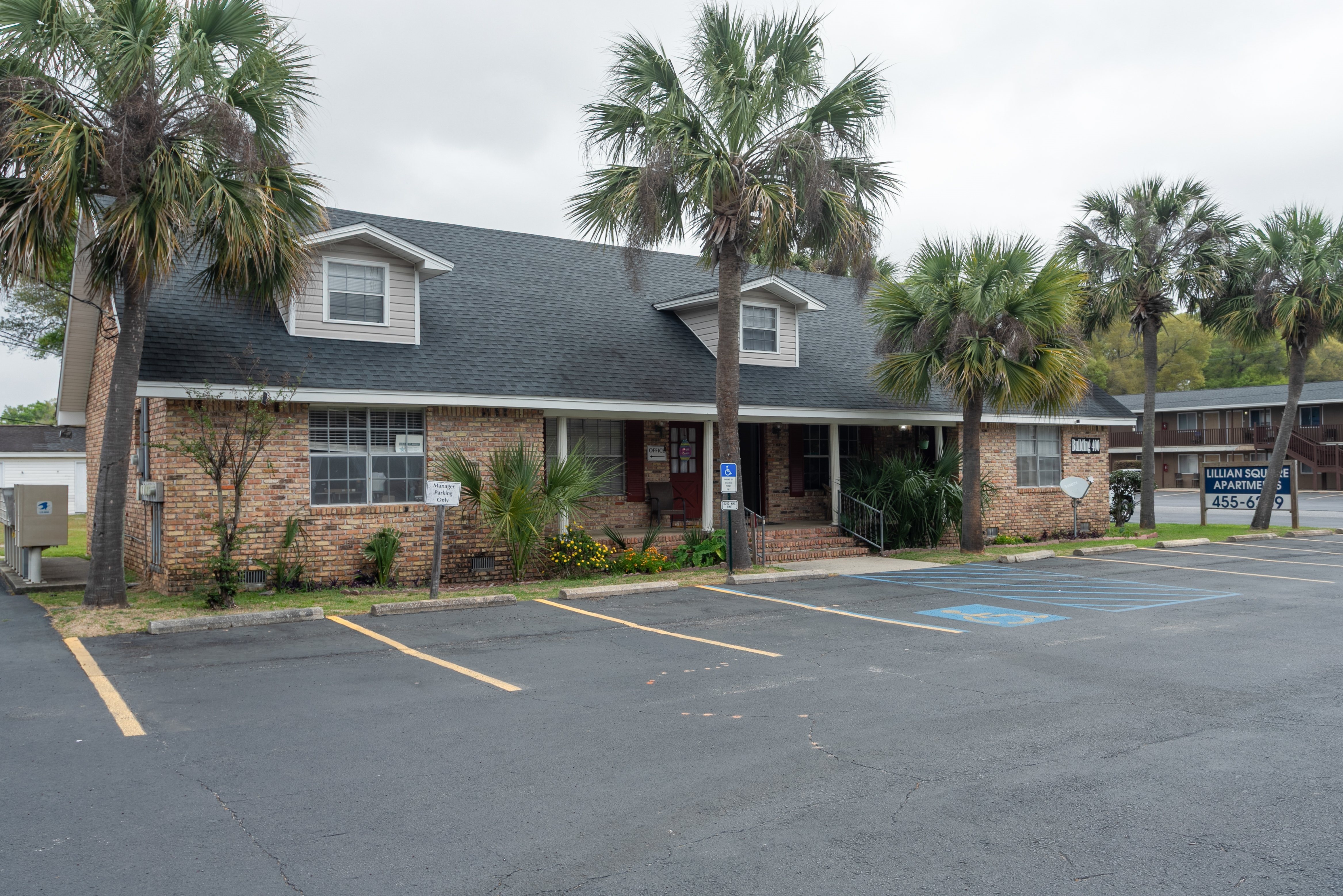 A building with a parking lot in front of it.